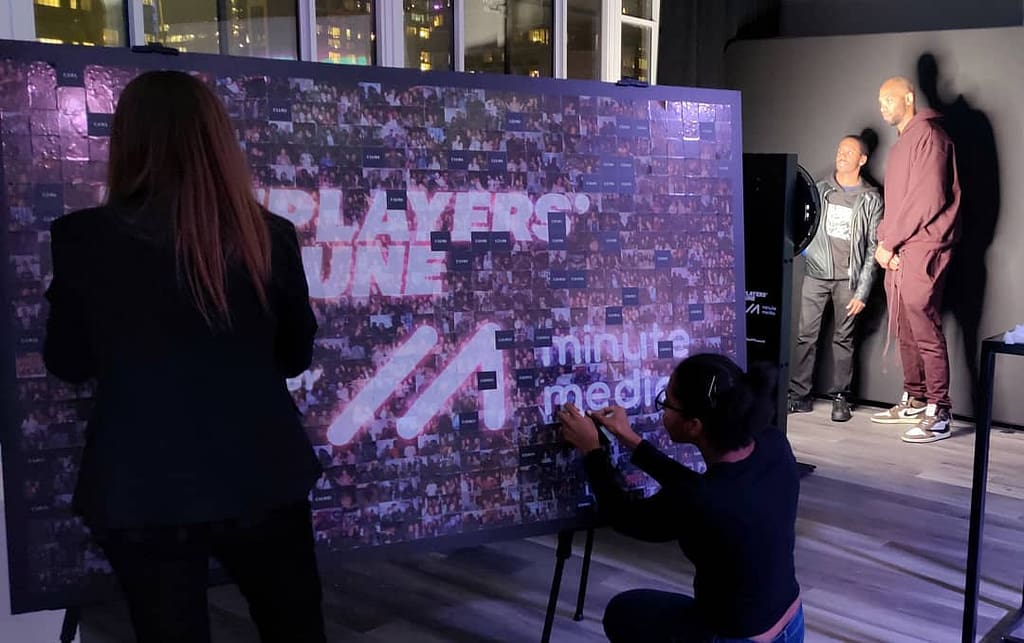 Guests completing the photo mosaic wall in London