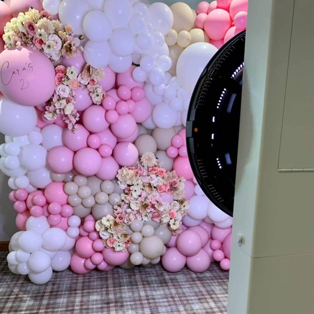Somerset photo booth in front of a pink balloon wall