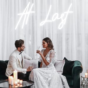 Wedding couple in front of their neon sign